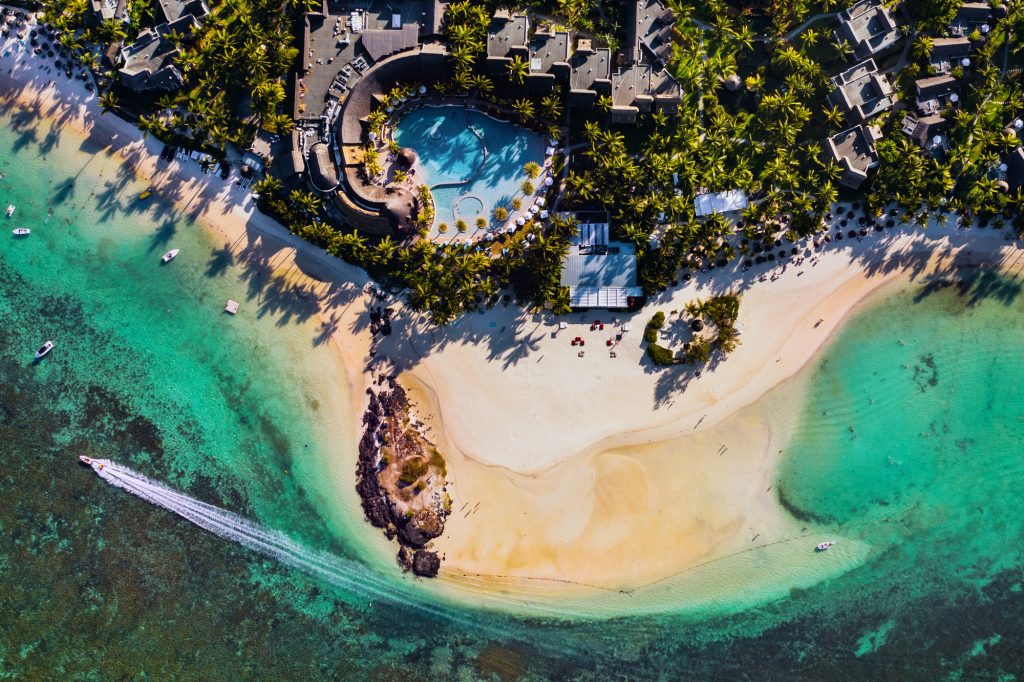Aerial picture of the east coast of Mauritius Island. Flying above the turquoise lagoon of Mauritius