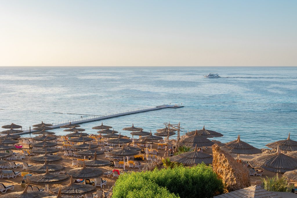 Panoramic view of beach Ras Umm El Sid. Beautiful sunrise over Red Sea with rocky shores, sandy beac