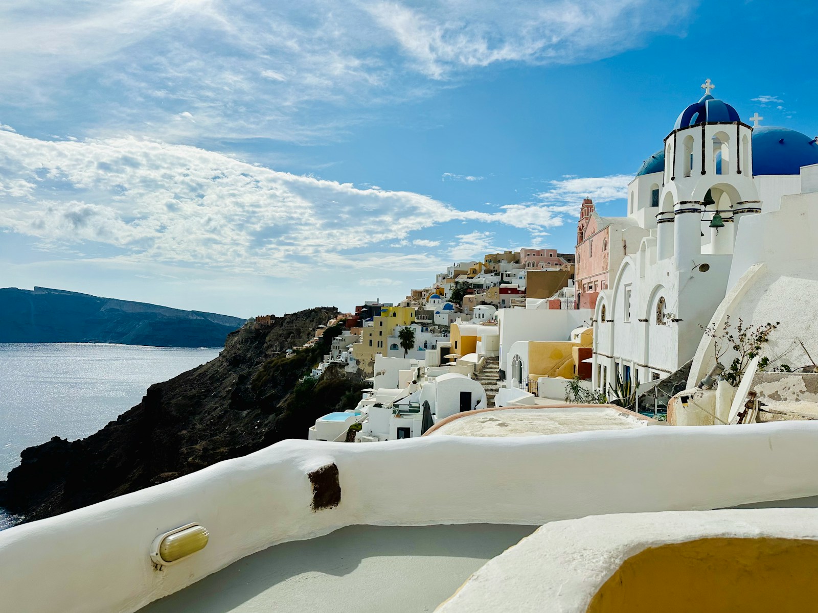 A white building with a blue dome on the top of it